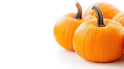 Obraz premium Pumpkin Harvest: A close-up studio shot featuring a cluster of ripe, vibrant pumpkins. They are perfectly illuminated, and their forms are enhanced by the interplay of light and shadow.