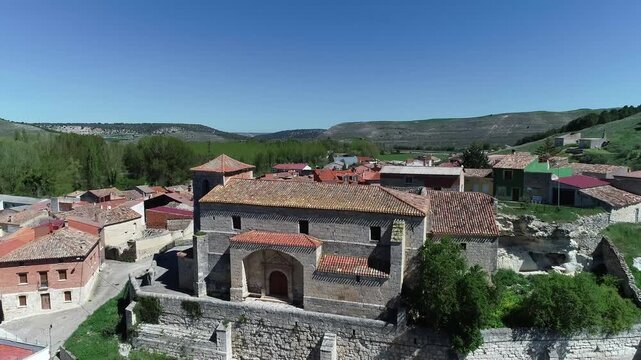 Aerial video with drone San Roman Church in Cobos de Cerrato surrounded by rustic village rooftops