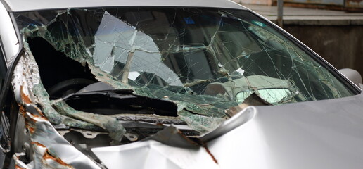 The broken cracked windscreen of a car