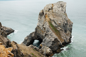 Naklejka premium Ursa Beach near Cabo da Roca in Portugal is a secluded wild beach with dramatic cliffs, unique rock formations, and Atlantic waves. High quality stock photo