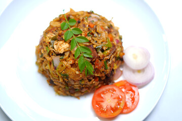 Chicken Kottu with Gravy Served on White Plate Close-Up. tomato, onion, curry leaves.