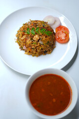 Asian Street Food Kottu with Chicken Curry and Curry Leaf Garnish.