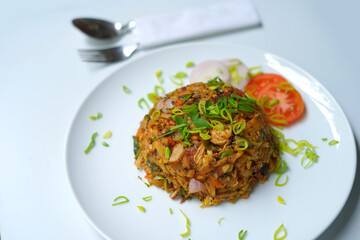 Flavorful Chicken Kottu Roti with Spoon, Fork, and Fresh Herbs.