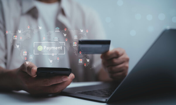 Man holding smartphone and credit card with digital payment system icons on world map. Concept of online shopping financial transaction fintech e-commerce and secure global banking technology
