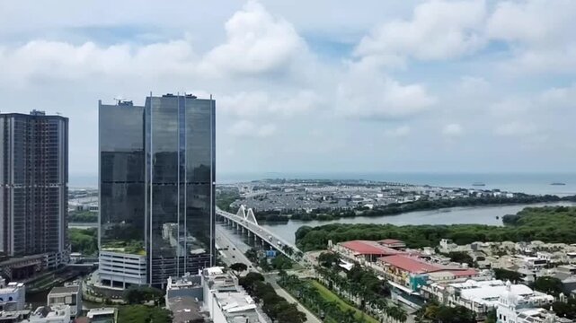 Aerial hyperlapse view of the modern cityscape of North Jakarta, Indonesia, captures the fast-paced metropolitan life, with dynamic skies and moving clouds.