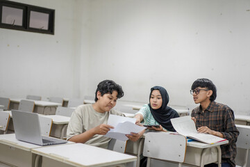 Collaborative Student Team in Classroom Focused on Studies, Analyzing Documents, and Utilizing Technology for Academic Success, Emphasizing Group Work and Learning