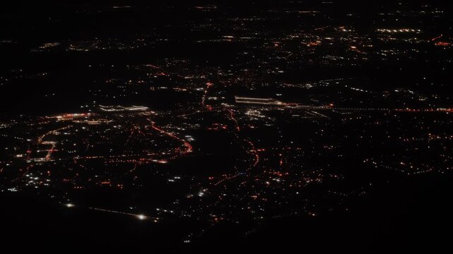Night shot of the city beautiful lights from the window of the plane.