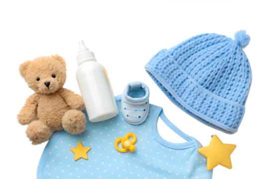Adorable collection of baby boy essentials with a teddy bear, feeding bottle, and blue clothing set isolated on a white background for a baby shower concept