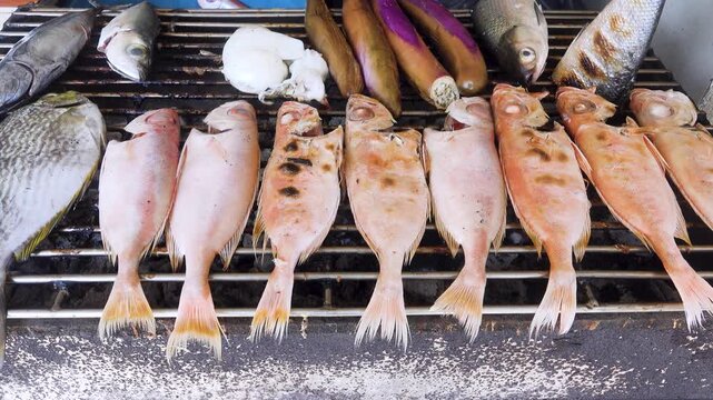 South Asia. Grilled seafood - fish, squid and bananas as bread. Fish lunch menu