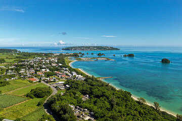 Fototapeta premium Scenic Aerial View of Yagaji Island (屋我地島) and Kouri Island (古宇利島) with Coastal Village and Beach, Okinawa, Japan
