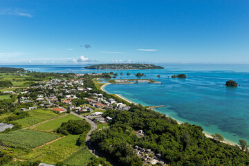 Fototapeta premium Scenic Aerial View of Yagaji Island (屋我地島) and Kouri Island (古宇利島) with Coastal Village and Beach, Okinawa, Japan