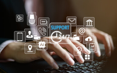 Professional hands typing on laptop surrounded by floating support service icons including 24/7 clock, AI, phone, email, chat, mobile and location. Comprehensive customer support ecosystem concept.