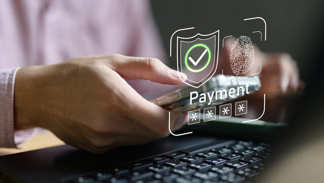 Professional hand using smartphone with secure payment interface showing security shield, fingerprint authentication and payment confirmation. Digital banking and mobile payment security concept.