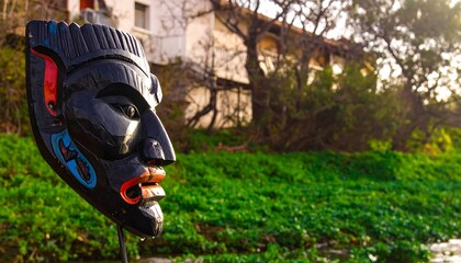 Black mask, profile view, outdoor setting