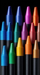 A vibrant collection of richly-pigmented crayons, arranged in a visually appealing, slightly staggered formation against a stark black backdrop