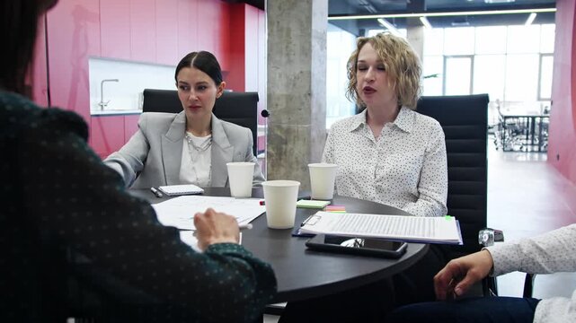 Startup team presents pitch deck to investors during acquisition meeting