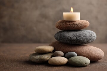 Serene Zen Stack of Smooth Stones with a Flickering Candle, Evoking Tranquility and Balance.