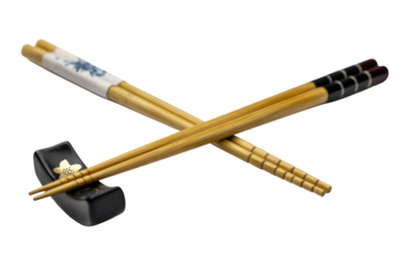Elegant pair of crossed chopsticks with a black chopstick rest, isolated on transparent background. background removed