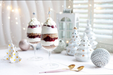 Latvian traditional dessert from dry rye bread layered  with whipped cream and cowberry jam served...