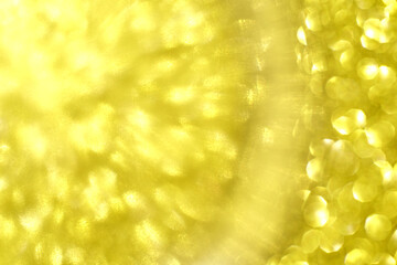 Abstract yellow light burst with circular bokeh effect and radiant highlights.