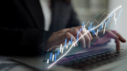 A business professional uses a laptop to analyze financial data, with a digital graph overlay representing significant upward trends and market insights, enhancing decision-making. Copula