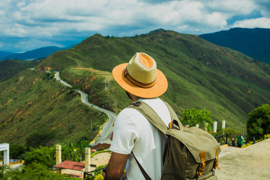 Young hispanic man with backpack admiring mountain view in Panachi Colombia