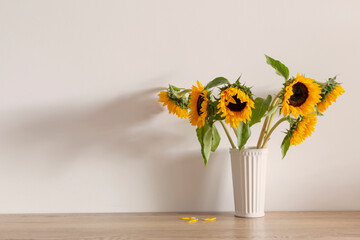 summer bouquet with sunflowers on background white wall