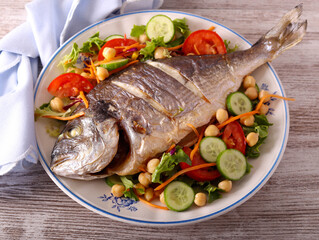 Baked whole gilthead bream fish with chickpea salad
