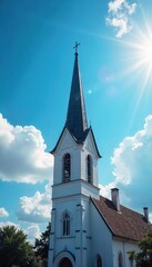 Serene church steeple reaching towards a vibrant blue sky, sunlit clouds, peaceful scene Perfect for religious, faith, hope, spiritual, travel, architecture themes , inspirational, travel