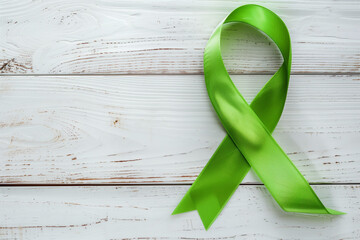 Lime Green Ribbon on white wooden background, world Mental health day. Lime GreenRibbon, world Mental health day