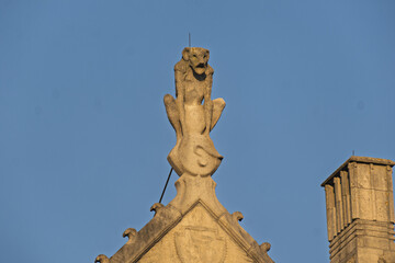 Statue of a monkey on the roof of a building in the zoo of Antwerp, Belgium