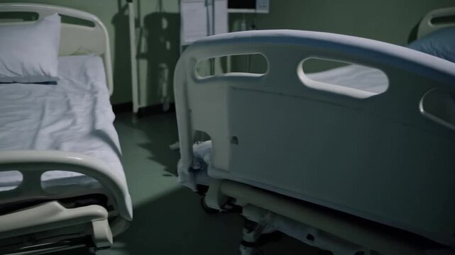 side view of empty and unoccupied hospital bed made with clean white sheets in ward room