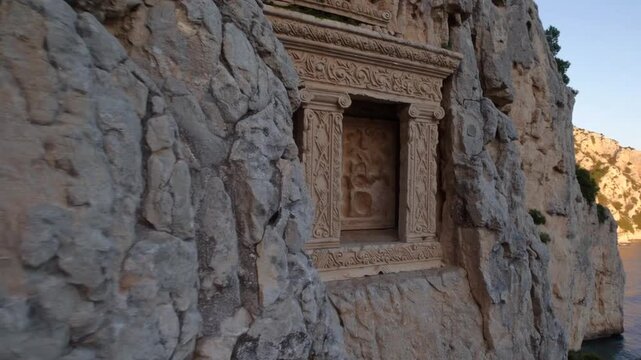 The ancient Lycian Rock Tombs carved into the cliff face in Kalekoy, Kekova, near Antalya