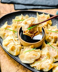 Deliciously presented dumplings with dipping sauce