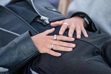 Close-up of a girl or woman lying with open hands on her belly, dressed in casual clothing...