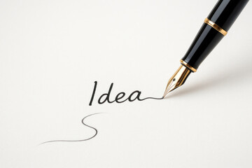 The pen writes the word Idea on the paper. Space for text.