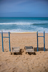 Empty Sun Loungers and Umbrellas on a Sandy Beach