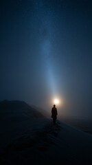 Fototapeta premium A solitary figure walks through a desert under a starry night sky with a bright moon, evoking mystery and tranquility.
