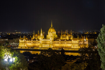 Night panorama from Fisherman's Bastion wall of illuminated Hungarian Parliament with neo-Gothic...