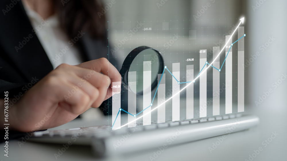 Poster a business professional engages with financial data on a keyboard, analyzing growth charts and trend