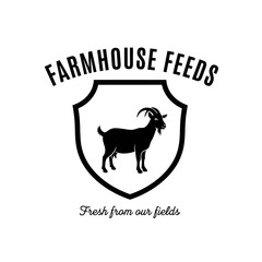 A black and white logo for Farmhouse Feeds, featuring a goat inside a shield with the tagline 'Fresh from our fields'.