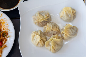 Steamed Delights: Fluffy Uyghur Momo Served with Soy Sauce