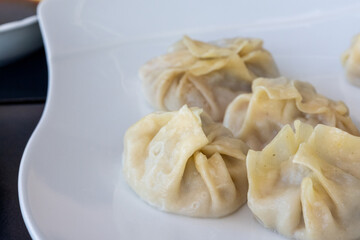 Steamed Delights: Fluffy Uyghur Momo Served with Soy Sauce