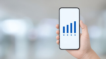 Smartphone held in hand showing blue signal bars with five stars below on white screen, symbolizing strong network connection and high rating