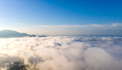 High altitude view of clouds over mountain peaks