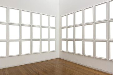 Fototapeta premium White art gallery interior with empty frames arranged on two walls. Minimalist mockup exhibition