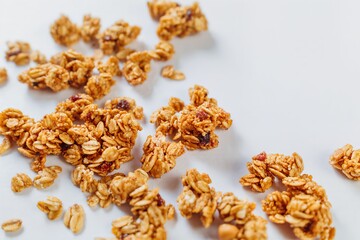 Delicious and nutritious granola clusters beautifully scattered on a bright and clean white background