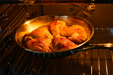 chicken legs are baked in the oven in the kitchen