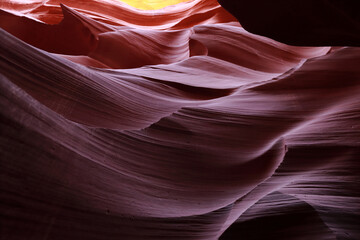 The pattern on the rock was created millions of years ago and resembles waves on the sea. The color of the pattern is mostly red. Arizona, 2024