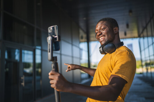 Excited influencer creating content with smart phone gimbal